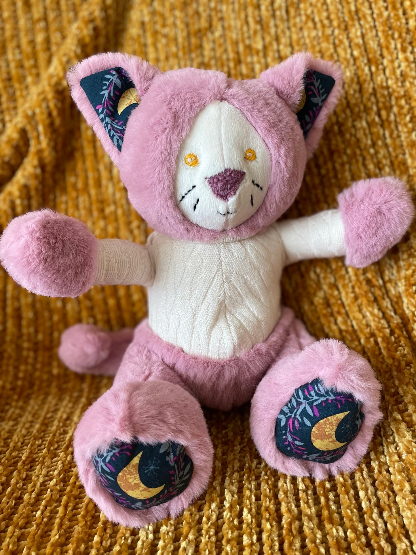 Pink Cat in an Ivory Knit Sweater